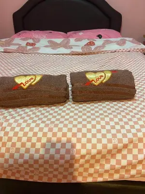 two towels sitting on top of a bed at Kittiya Mansion in Ban Phlu Nai