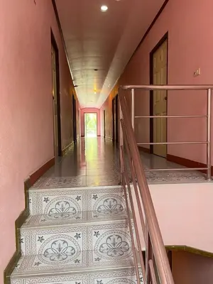 an empty hallway with stairs in a house at Kittiya Mansion in Ban Phlu Nai