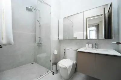 a bathroom with a shower and a toilet and a sink at Casa tua, luxury 2bed - Canvas by Sansiri in Laguna Phuket