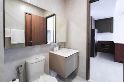 a bathroom with a toilet and a sink and a mirror at Casa tua, luxury 2bed - Canvas by Sansiri in Laguna Phuket