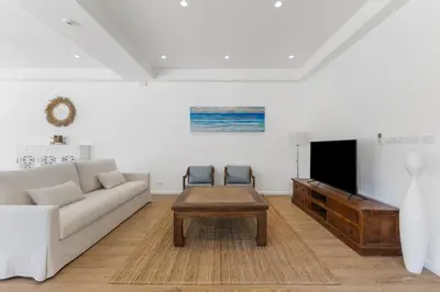 a living room with a couch and a coffee table at Coastal Villa on Fairway 3 Bedroom in Laguna Phuket