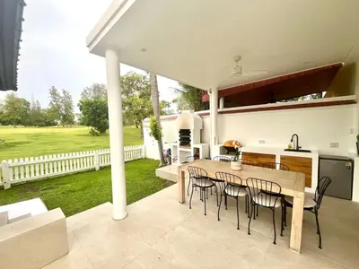 a kitchen and dining room with a table and chairs at Coastal Villa on Fairway 3 Bedroom in Laguna Phuket