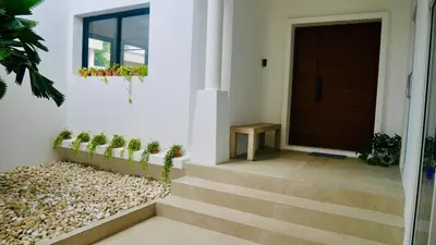 a house with stairs leading to a door at Coastal Villa on Fairway 3 Bedroom in Laguna Phuket