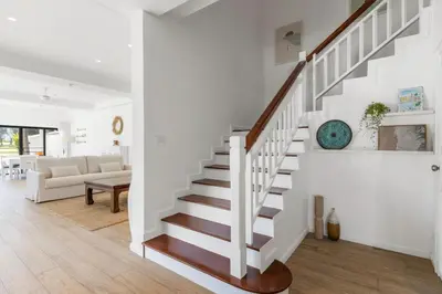 a staircase in a home with a living room at Coastal Villa on Fairway 3 Bedroom in Laguna Phuket