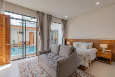 a bedroom with a bed and a couch at Taraburi 6BR Pool Villa Phuket VVPHU91 in Thalang