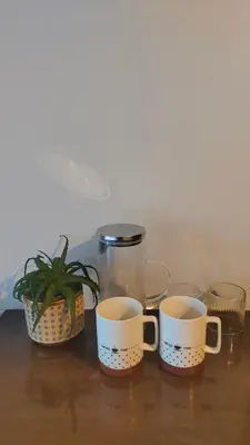 three cups sitting on a table with a plant at Aonang room rent in Ban Khlong Haeng