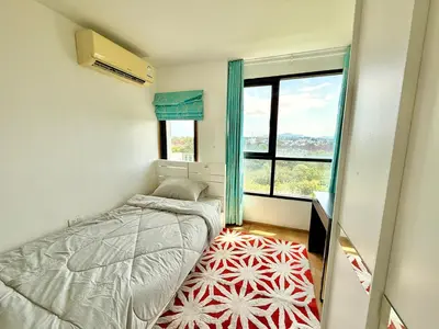 a small bedroom with a bed and a window at MiCasa - 2BR Centrio 7th Floor in Ban Rangeng