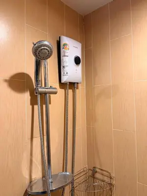 a bathroom with a blow dryer on the wall at MiCasa - 2BR Centrio 7th Floor in Ban Rangeng