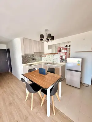 a kitchen with a table and chairs and a refrigerator at MiCasa - 2BR Centrio 7th Floor in Ban Rangeng