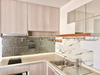 a kitchen with white cabinets and a sink at MiCasa - 2BR Centrio 7th Floor in Ban Rangeng