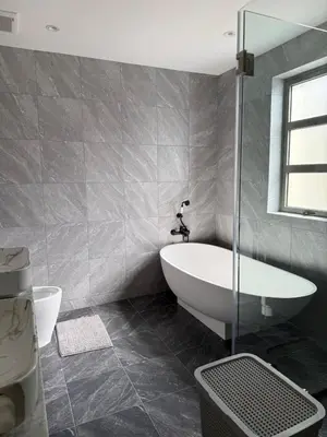 a bathroom with a tub and a glass shower at Bella Home 2BR Pool Villa min to Bang Tao Beach in Ban Thalat Choeng Thale