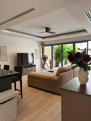 a living room with a couch and a television at Bella Home 2BR Pool Villa min to Bang Tao Beach in Ban Thalat Choeng Thale