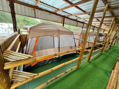 a couple of tents sitting inside of a building at The Tent Naiyang in Nai Yang Beach