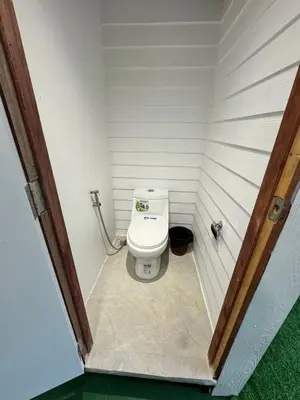 a small bathroom with a toilet in a room at The Tent Naiyang in Nai Yang Beach