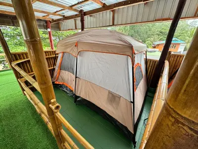 a tent is inside of a building with grass at The Tent Naiyang in Nai Yang Beach