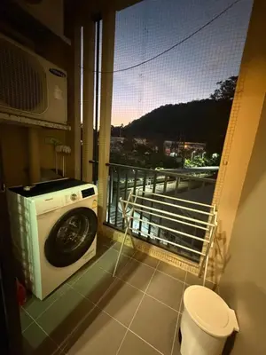 a washing machine in a room with a balcony at The base up town phuket
