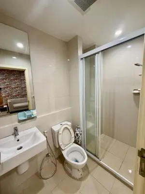 a bathroom with a toilet and a sink and a shower at The base up town phuket