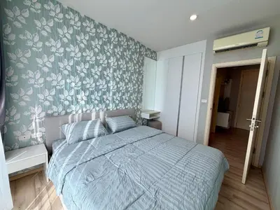 a bedroom with a bed with a floral wallpaper at The base up town phuket