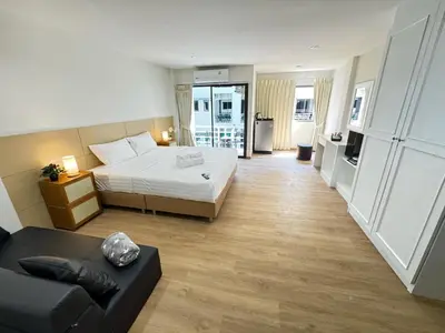 a hotel room with a bed and a couch at Top hotel in Patong Beach