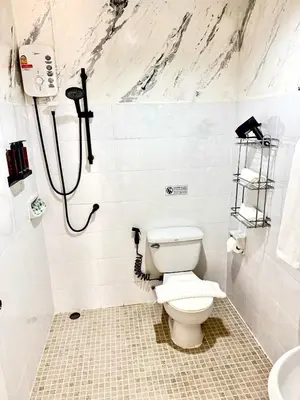 a bathroom with a toilet and a shower at Top hotel in Patong Beach