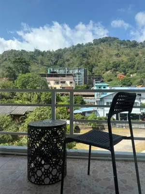a black chair sitting on top of a balcony at Top hotel in Patong Beach