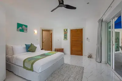 a bedroom with a bed and a ceiling fan at Elegant 2BR Pool Villa Overlooking Loch Palm Golf - Baan Sawan Garden Villa in Kathu