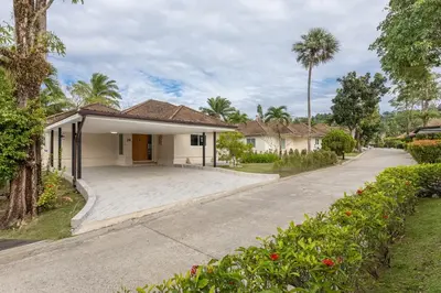 a house with a driveway in front of it at Elegant 2BR Pool Villa Overlooking Loch Palm Golf - Baan Sawan Garden Villa in Kathu