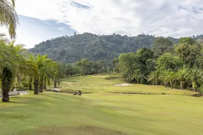 a view of a golf course with palm trees at Elegant 2BR Pool Villa Overlooking Loch Palm Golf - Baan Sawan Garden Villa in Kathu