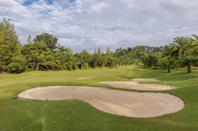 a view of a golf course with a sand bunker at Elegant 2BR Pool Villa Overlooking Loch Palm Golf - Baan Sawan Garden Villa in Kathu