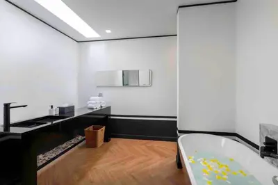 a bathroom with a bath tub and a sink at Mono Villas Pasak - Three Bedroom Pool Villa in Bangtao in Ban Pak Lak