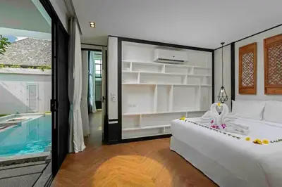 a bedroom with a bed and a swimming pool at Mono Villas Pasak - Three Bedroom Pool Villa in Bangtao in Ban Pak Lak