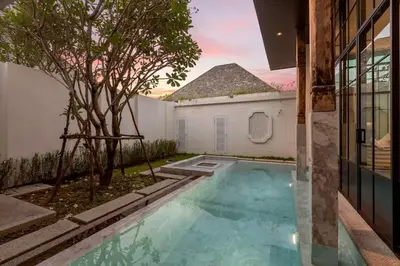 a swimming pool in the backyard of a house at Mono Villas Pasak - Three Bedroom Pool Villa in Bangtao in Ban Pak Lak