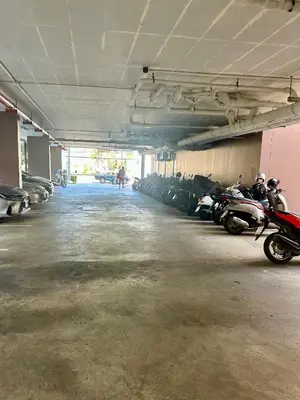 a parking garage with a bunch of motorcycles parked in it at Phuket Kata Studio Apartment in Kata Beach