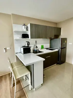 a small kitchen with a sink and a refrigerator at Phuket Kata Studio Apartment in Kata Beach