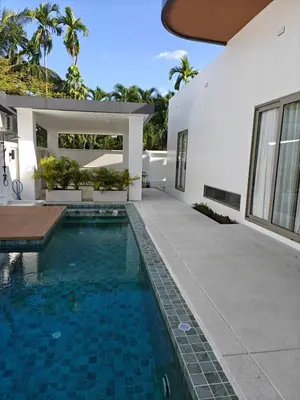 a swimming pool in the backyard of a house at V-004 4 BR Unique Villa Baan Bua in Rawai Beach