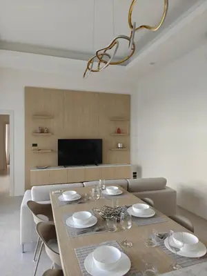 a dining room with a table with chairs and a television at V-004 4 BR Unique Villa Baan Bua in Rawai Beach