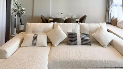 a white couch with pillows on it with a table at Chardonnay Naiharn 1BR spacious apart BRAND new in Rawai Beach