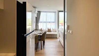 a dining room with a table and a window at Chardonnay Naiharn 1BR spacious apart BRAND new in Rawai Beach