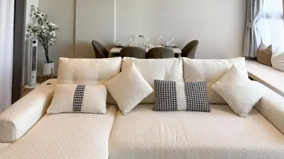 a white couch with pillows on it with a table at Chardonnay Naiharn 1BR spacious apart BRAND new in Rawai Beach