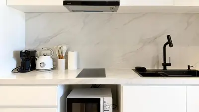 a kitchen with a sink and a counter top at Chardonnay Naiharn 1BR spacious apart BRAND new in Rawai Beach
