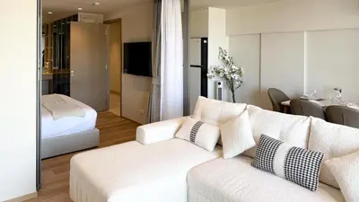 a living room with a white couch and a bedroom at Chardonnay Naiharn 1BR spacious apart BRAND new in Rawai Beach