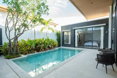 an indoor swimming pool in the backyard of a house at Holiday pool villa in Ban Na Nai