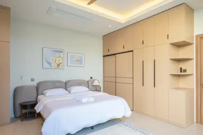 a bedroom with a large bed and a large closet at Holiday pool villa in Ban Na Nai