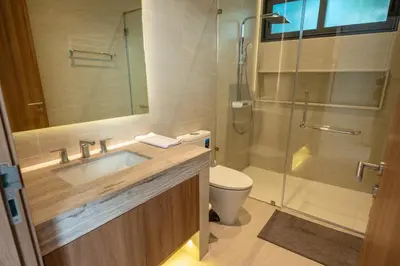 a bathroom with a sink and a shower and a toilet at Holiday pool villa in Ban Na Nai