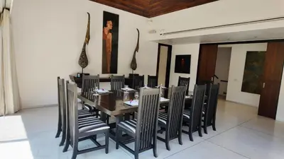 a dining room with a wooden table and chairs at Villa Samakee Luxury 5 Bedroom Villa in Ban Thalat Choeng Thale