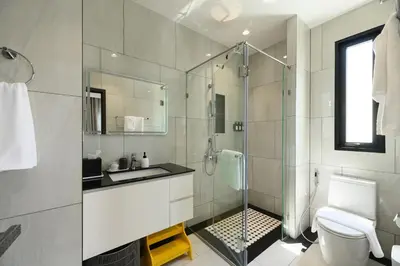 a bathroom with a shower and a sink and a toilet at High-end 1BR at Title Bangtao by Sabay Rent E704 in Bang Tao Beach