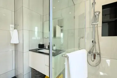 a white bathroom with a shower and a sink at High-end 1BR at Title Bangtao by Sabay Rent E704 in Bang Tao Beach