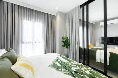 a bedroom with a bed and a large window at High-end 1BR at Title Bangtao by Sabay Rent E704 in Bang Tao Beach