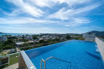 a swimming pool on the roof of a building at 1 BR Balcony Pool and Garden View - Babylon Sky M206 in Rawai Beach