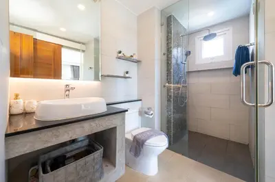 a bathroom with a sink and a toilet and a shower at 1 BR Balcony Pool and Garden View - Babylon Sky M206 in Rawai Beach